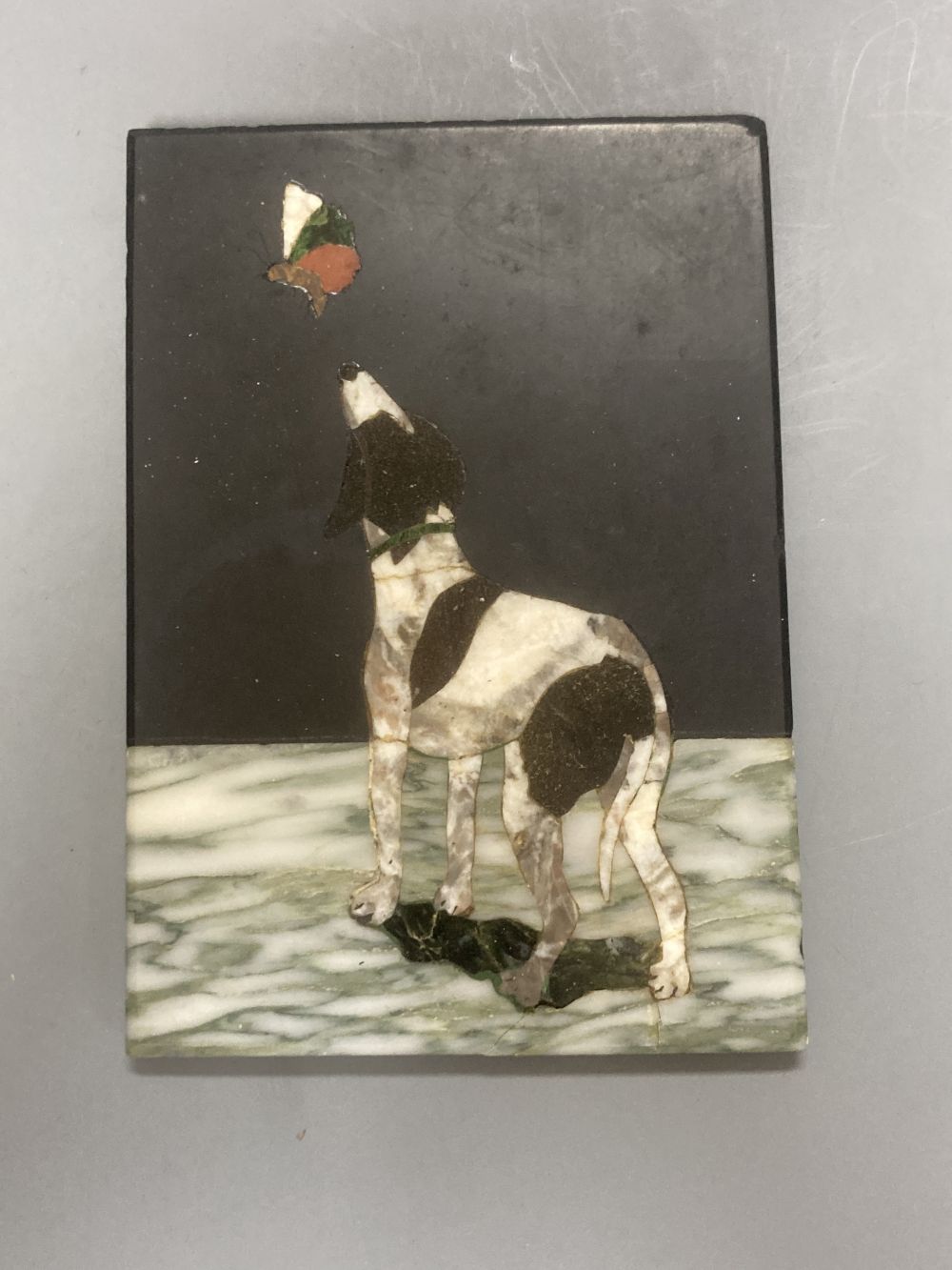 A Neapolitan pietra dura plaque, depicting a dog and a butterfly, 13 x 9cm and a moulded composition plaque